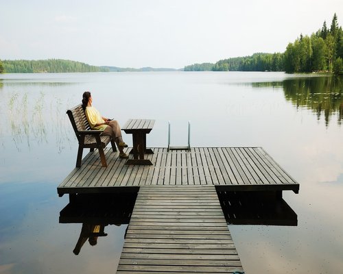 Person drinking water and resting on a gym bench